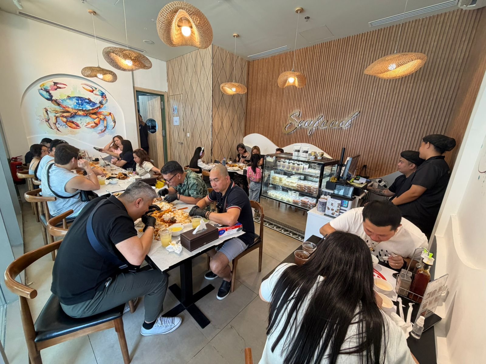 A group of friends sharing a seafood feast around a long table